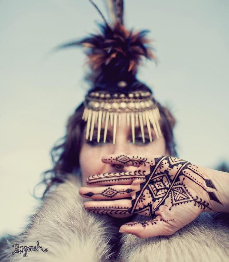 Portrait of Melodia wearing an elaborate headdress and intricate henna designs, capturing the creativity, imagination, and artistic expression celebrated in Melodia the Artist.