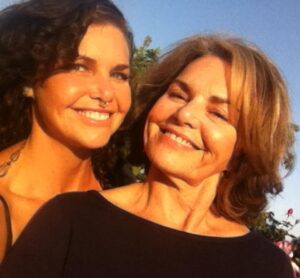 Melodia and Deborah Medley sharing a warm mother-daughter moment, reflecting the love, memory, and family connections explored in Ofrendas.