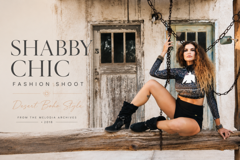 Boho desert fashion editorial featuring Melodia Medley in a patterned crop top and black moto shorts posed on a rustic wooden swing against a weathered desert backdrop.