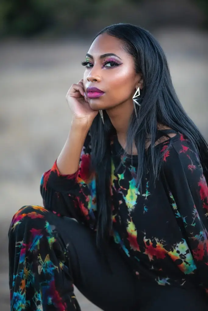 Colorful tie-dye outfit from Melodia Designs' Black Prism Tie-Dye Collection in nature.