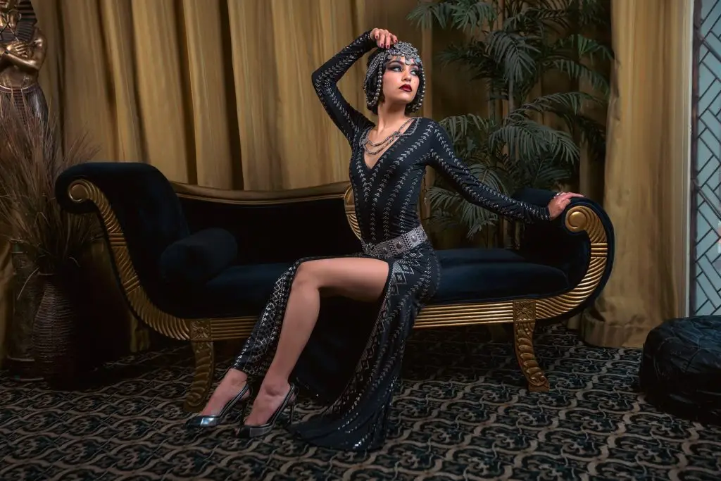 Elegant woman in glamorous black dress from the Melodia Designs Roaring 2020s Pinstripe Collection.