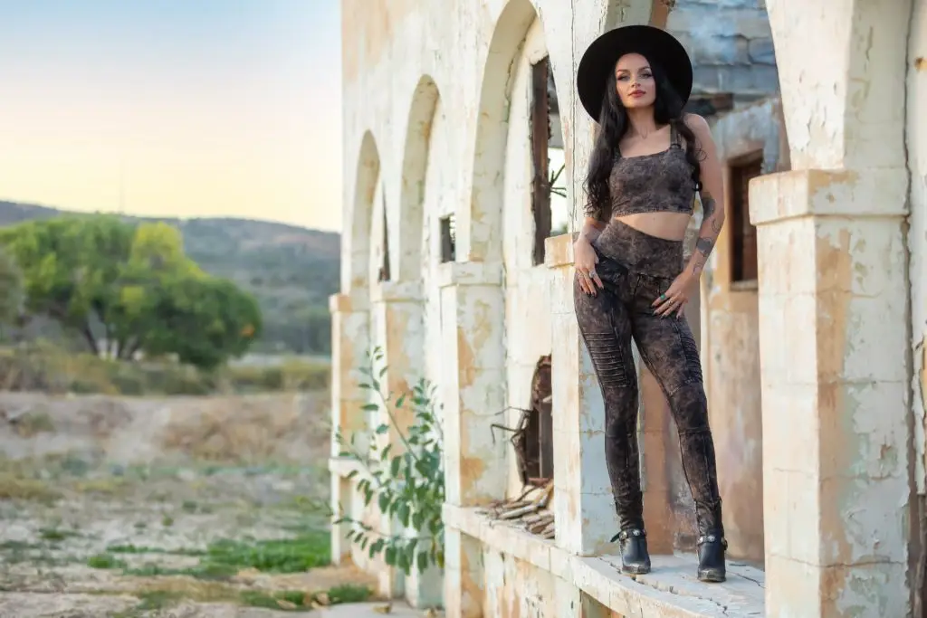 Woman in stylish Star Tarot & Smoky Quartz Collection in boho style archways.