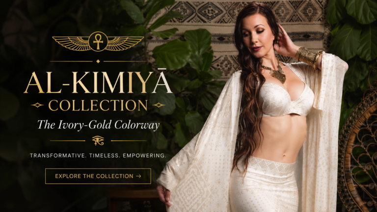 Featured image for the Al-Kīmiyā Collection by Melodia Designs featuring the Ivory-Gold colorway, showcasing a model in flowing Egyptian-inspired ivory fashion with metallic gold detailing, styled in a lush botanical setting with bohemian decor and regal jewelry.