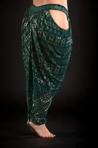 Model wearing the ISHA Assuit pantaloon in malachite green with gold geometric patterning.
