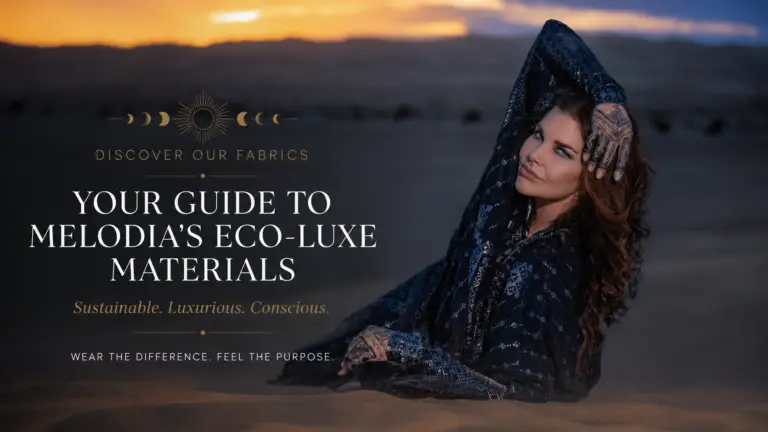 Featured image for Melodia Designs’ eco-luxe fabrics guide featuring a woman draped in black patterned fabric reclining in desert sand at sunset, with elegant editorial typography highlighting sustainable luxury materials.