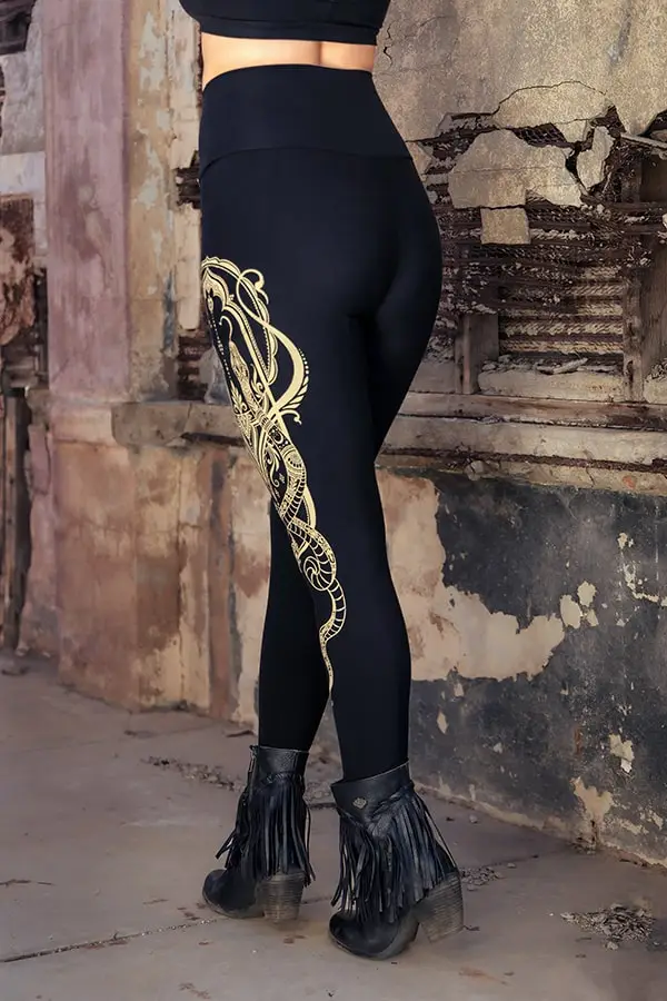 Serpent design close-up on black fabric, capturing precision of linework and flow.
