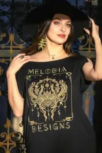 Close view of Serpent Jade Tunic by Melodia Designs featuring gold serpent design