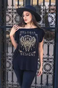 Woman wearing Serpent Jade Tunic by Melodia Designs with gold serpent graphic