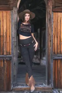 Woman wearing Rustique Moto black sacred geometry crop top and leggings outfit by Melodia Designs