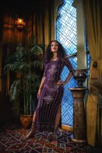 Front view of the Karnak Beledi dress in aubergine, featuring a flattering neckline and elegant drape.