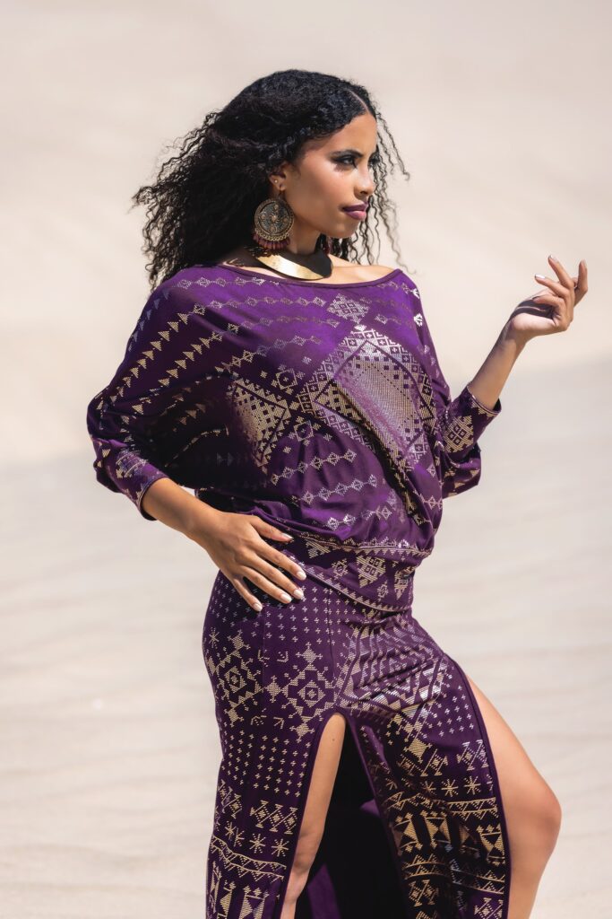 Model stretches in aubergine combination of Alkimiya & Karnak Collections — designed to flow with the body, made for dance and ritual.