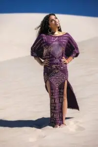 Full-body front view of a purple Karnak ensemble with intricate patterning, styled outdoors in natural light.