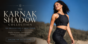 Karnak Shadow Collection featured image showcasing a model in black geometric activewear walking through sunlit desert dunes beneath a clear blue sky, styled in Melodia Designs’ signature slow-fashion aesthetic.