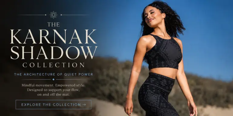 Karnak Shadow Collection featured image showcasing a model in black geometric activewear walking through sunlit desert dunes beneath a clear blue sky, styled in Melodia Designs’ signature slow-fashion aesthetic.