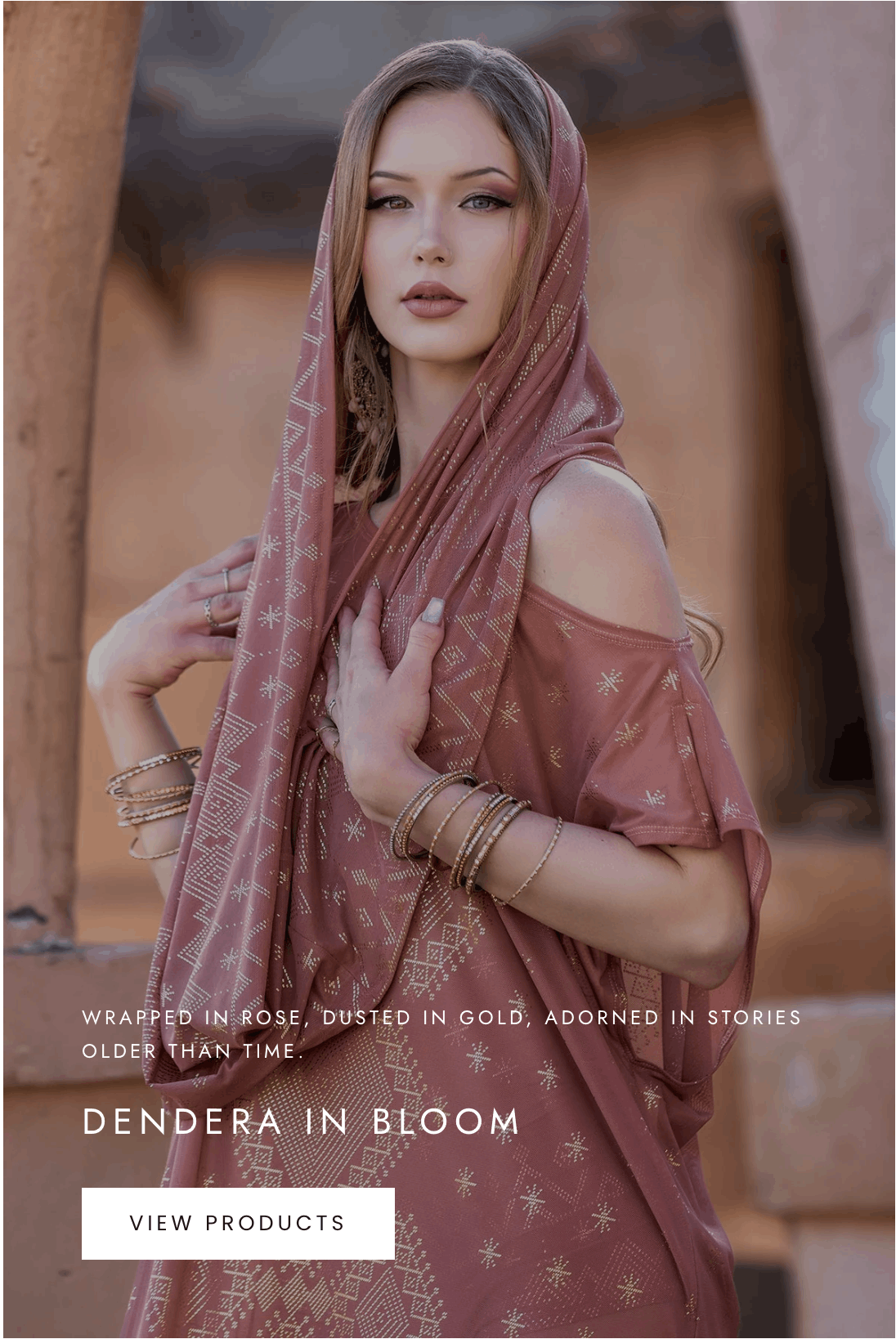 Model wearing Dendera Collection desert rose draped dress with gold detailing by Melodia Designs